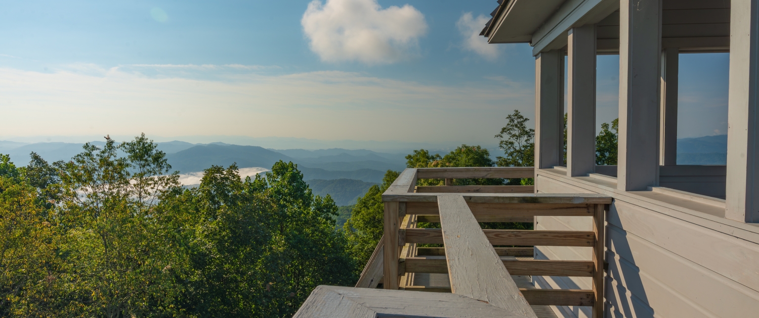From the top of Rich Mountain Fire Tower near Hot Springs, visitors enjoy 360 degree views, perfect for chasing fall foliage near Asheville.