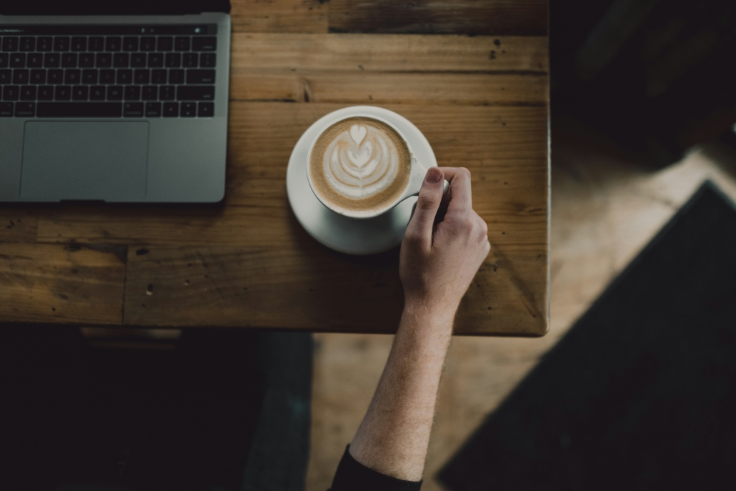 a remote worker enjoys a cappuccino at an Asheville coffee shop