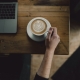 a remote worker enjoys a cappuccino at an Asheville coffee shop