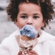 Girl in white coat with purple ice cream cone