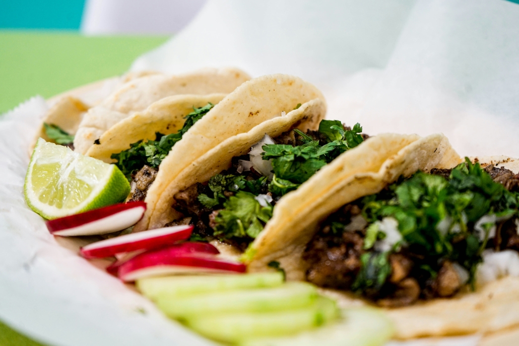Fresh tacos with sliced radishes and lime