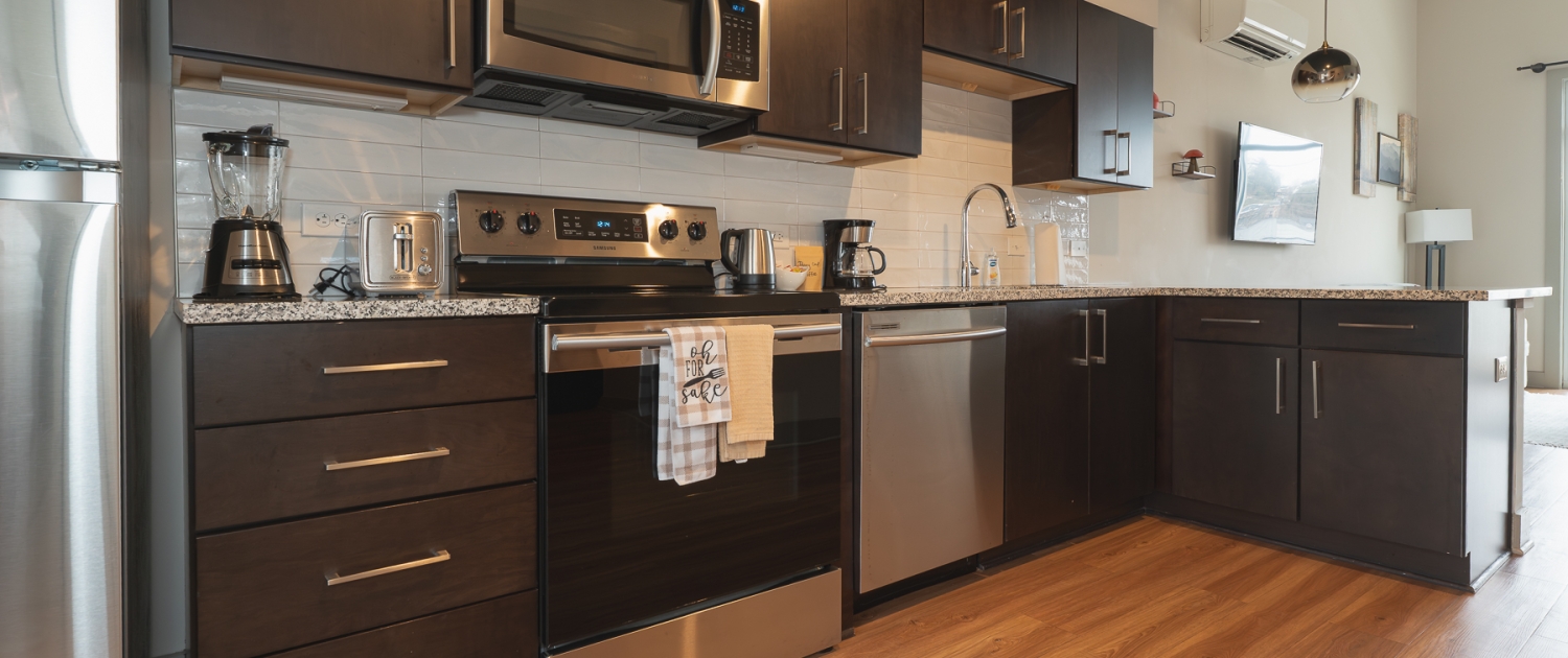 Full kitchen with full-sized appliances in a River Row suite, ready for cooking Thanksgiving dinner in Asheville