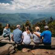 a family sits at an overlook in the blue ridge mountains